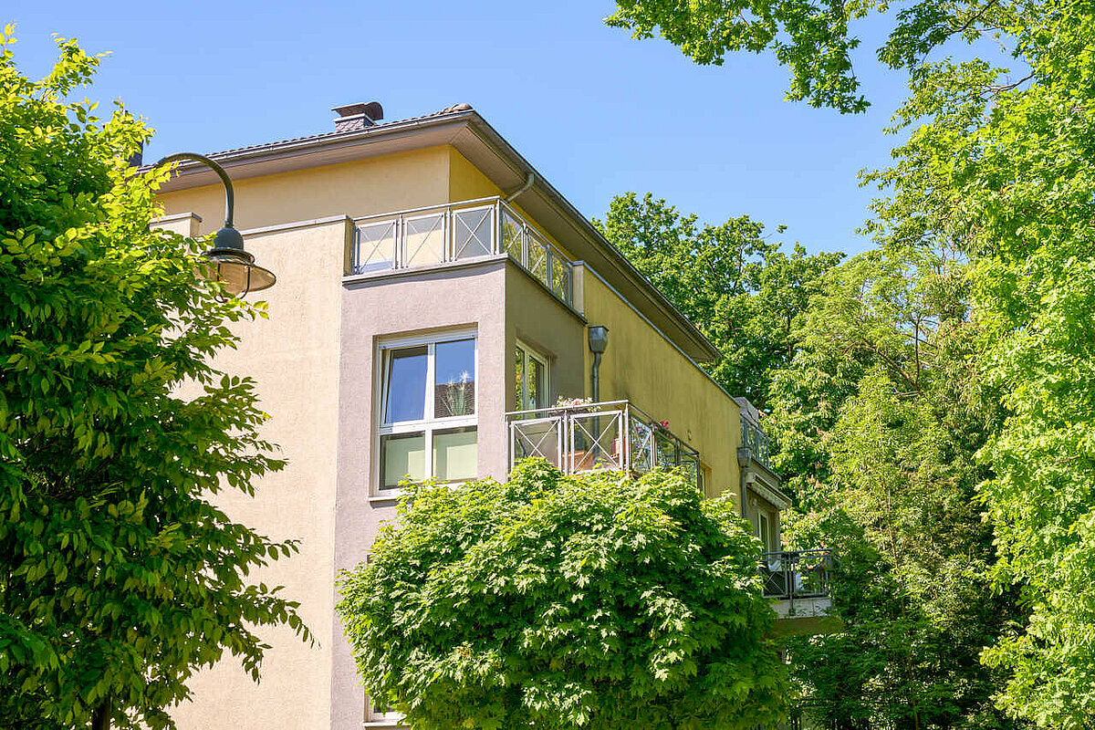 Außenansicht Balkon mit grünen Bäumen