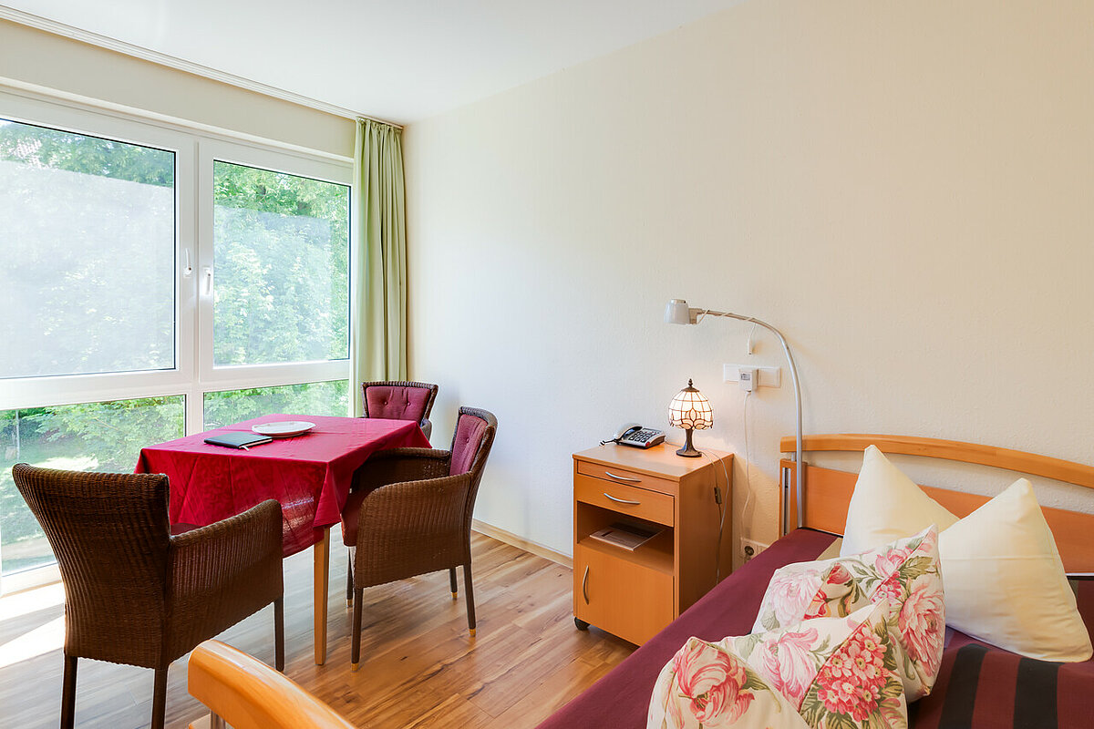 Beispielzimmer Bett, Tisch und Aussicht